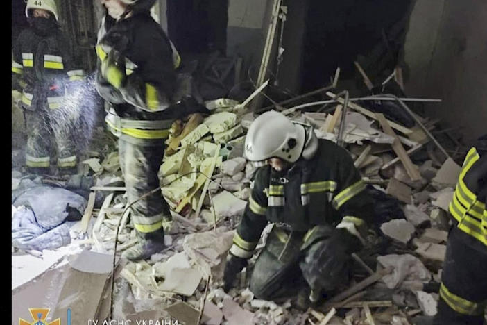 In this photo provided by the Ukrainian Emergency Service, first responders work a damaged residential building in Odesa, Ukraine, early Friday, July 1, 2022, following Russian missile attacks.