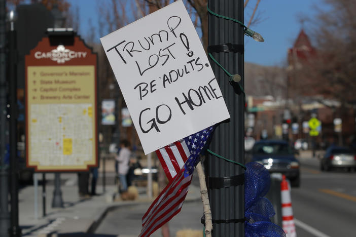 A sign in Carson City, Nevada in January 2021 calling on pro-Trump protesters, supporting his baseless claims of election fraud, to go home. Now, other candidates are following in Trump's footsteps.