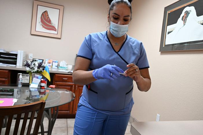 A medical assistant checks a patient's pregnancy test at the Women's Reproductive Clinic, which provides legal medication abortion services, in Santa Teresa, N.M., in a photo taken last month.