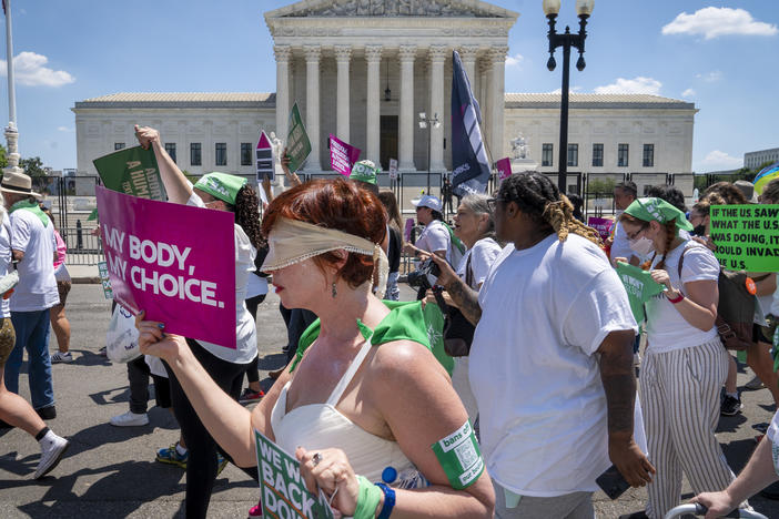 Mahayana Landowne, of Brooklyn, N.Y., wears a "Lady Justice" costume as she marches past the Supreme Court during a protest for abortion rights on June 30, 2022, in Washington, D.C.