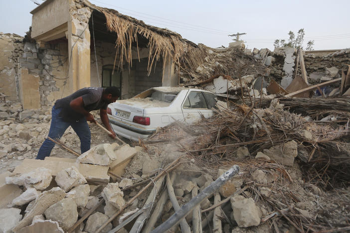 A man cleans up rubble after an earthquake at Sayeh Khosh village in Hormozgan province in Iran, some 620 miles south of the capital Tehran on July 2, 2022.