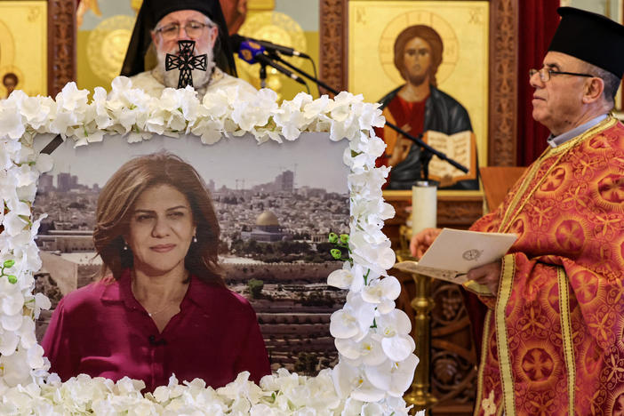Archimandrite Abdullah Yulio, parish priest of the Melkite Greek Catholic church in Ramallah, speaks during a memorial service in June for the late Palestinian and veteran Al Jazeera journalist Shireen Abu Akleh. The Palestinian Authority says it has shared the bullet that killed Abu Akleh with U.S. officials.