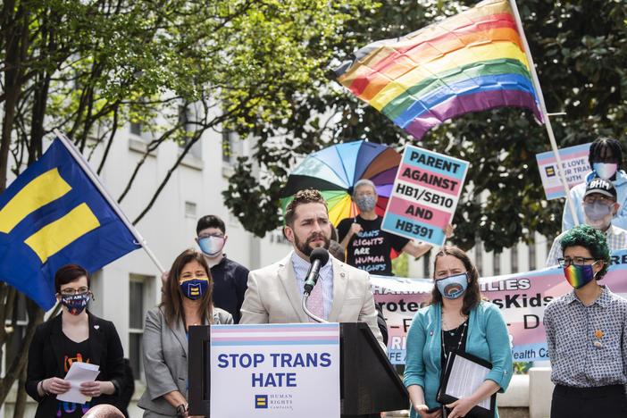 Alabama Rep. Neil Rafferty speaks in support of transgender rights during a rally outside the Alabama State House in 2021. The state is using the<em> Dobbs</em> ruling, which overturned <em>Roe v. Wade</em> and ended abortion access as a federal right, to argue it has the authority to ban gender-affirming medical care.