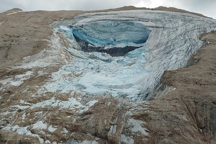 This image released on Sunday by the Italian National Alpine and Cave Rescue Corps shows the glacier in Italy's Alps near Trento, a large chunk of which has broken loose, killing at least six hikers and injuring others.