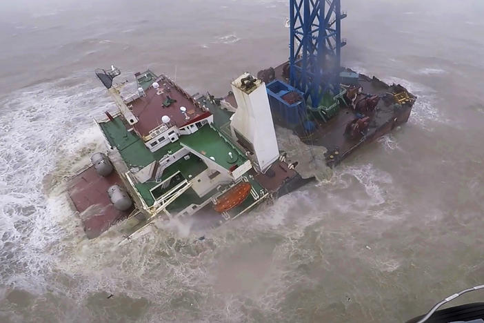 In this image released by the Hong Kong government, a helicopter with rescue crew members approaches a sinking ship in the South China Sea, 186 miles south of Hong Kong on July 2, 2022.