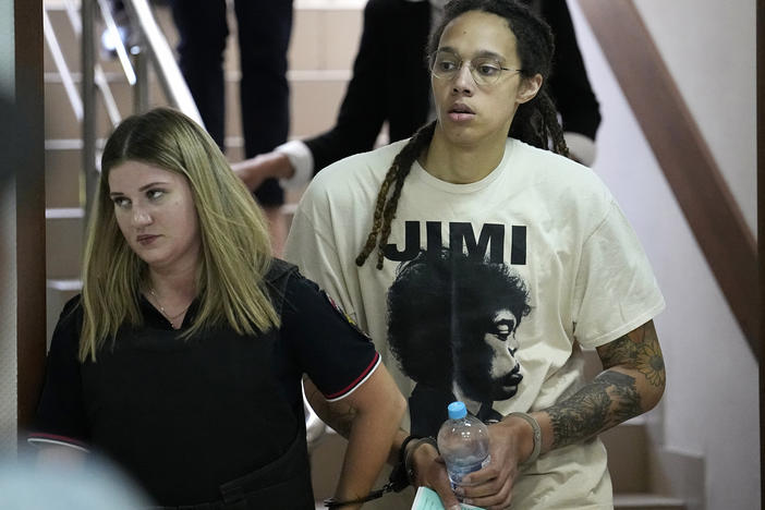 WNBA star and two-time Olympic gold medalist Brittney Griner is escorted to a courtroom for a hearing, in Khimki just outside Moscow, Russia, Friday, July 1, 2022.