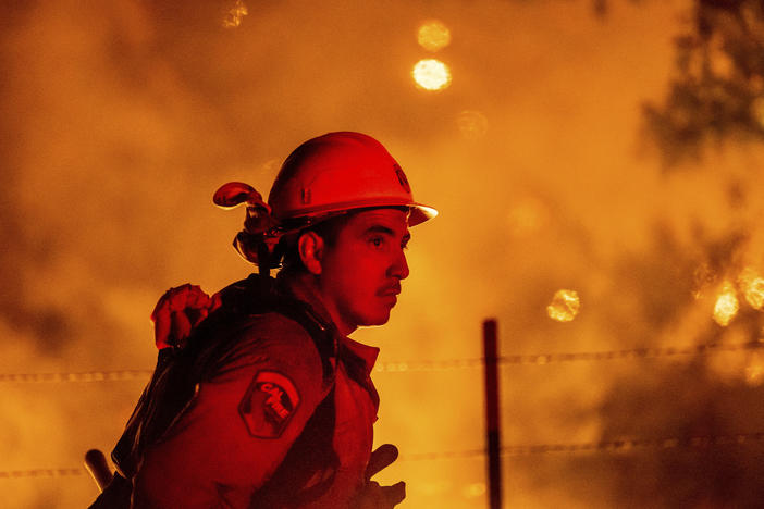 Firefighter Rafael Soto battles the Electra Fire burning in the Rich Gulch community of Calaveras County, Calif., on Tuesday, July 5, 2022.