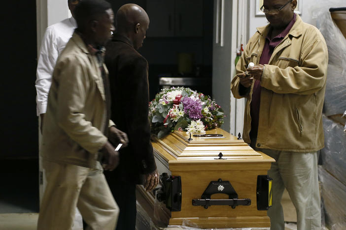 A coffin is prepared to be taken to a symbolic funeral in Scenery Park, East London South Africa, Wednesday, July 6, 2022.