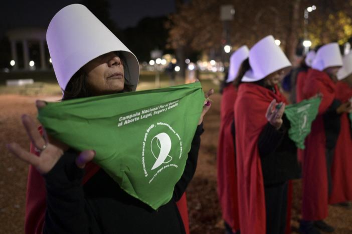 Pro-choice activists disguised as characters from the dystopian novel <em>The Handmaid's Tale</em> display green headscarves in front of the U.S. ambassador's residence in Buenos Aires, on June 30, 2022.
