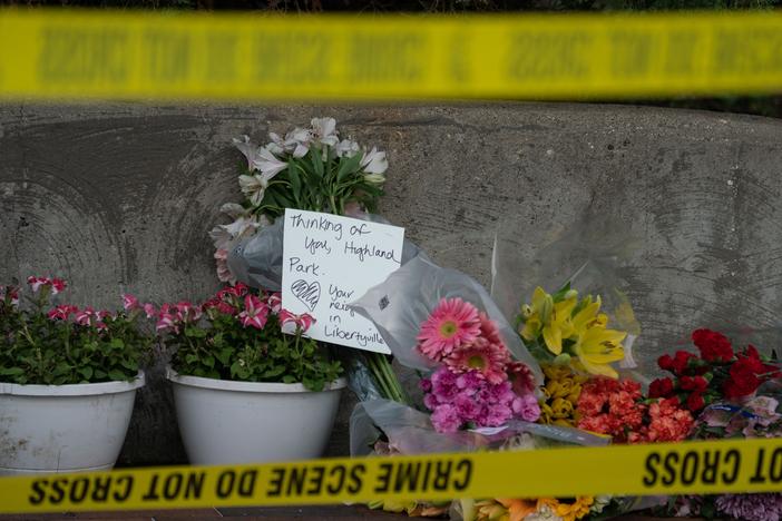 Flowers are left for victims of the 4th of July mass shooting in downtown Highland Park, Illinois.