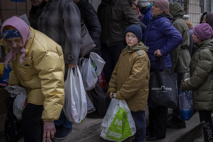 Sergei, 11, waits his turn to receive donated food during an aid humanitarian distribution in Bucha, in the outskirts of Kyiv, on Tuesday, April 19, 2022.