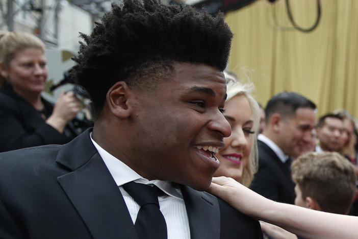 Jerry Harris talks to an actress on the red carpet at the Oscars in Los Angeles in 2020.