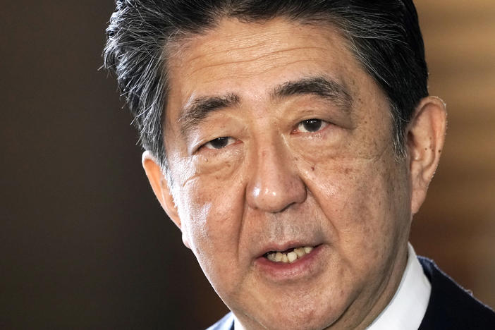 Japan's outgoing Prime Minister Shinzo Abe speaks to the media as he arrives at the prime minister's office for a cabinet meeting in Tokyo on Sept. 16, 2020.