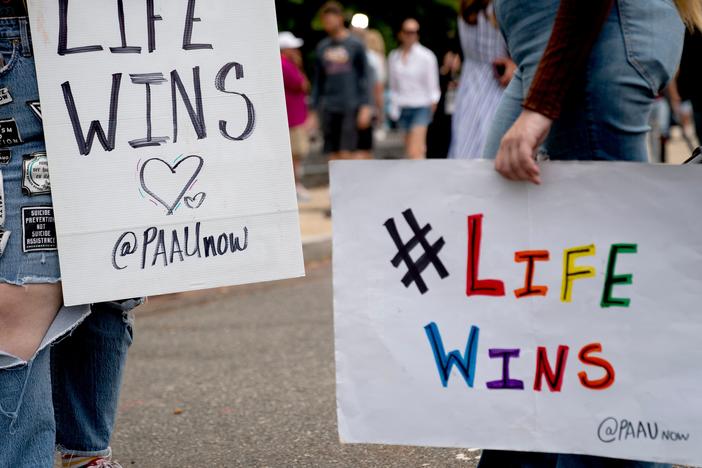 Abortion rights opponents hold signs outside the Supreme Court on June 27, 2022.