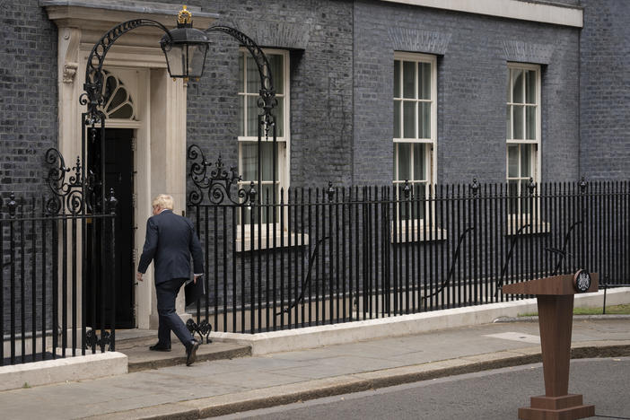 Prime Minister Boris Johnson walks back into 10 Downing St. after announcing his resignation as Conservative Party leader on Thursday.