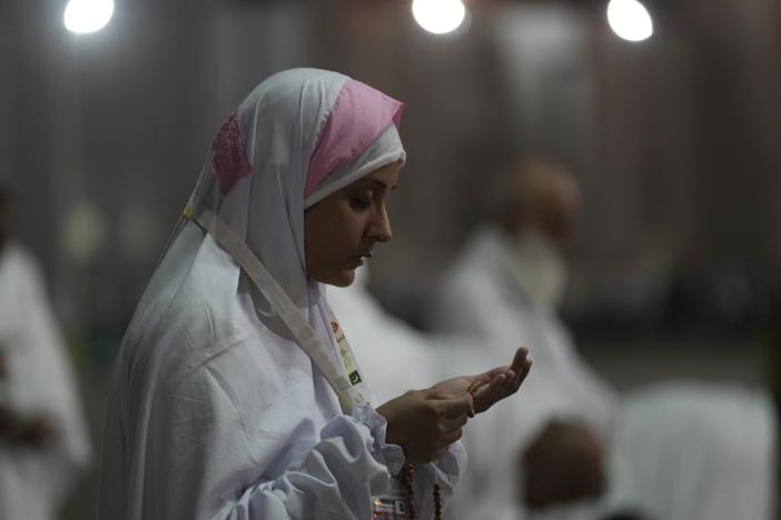 A Muslim pilgrim prays on the Plain of Arafat, during the annual hajj pilgrimage, near the holy city of Mecca, Saudi Arabia, Friday, July 8, 2022.