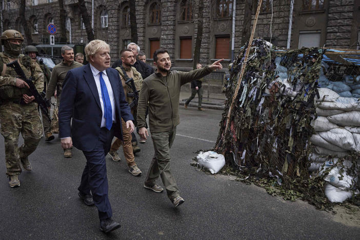 Ukrainian President Volodymyr Zelenskyy, center, and Britain's Prime Minister Boris Johnson walk in downtown Kyiv, Ukraine, in April . Johnson may have been shown the door in Britain, but he remains a popular figure in Ukraine, where he is admired for his support for the country's effort to repel the Russian invasion.