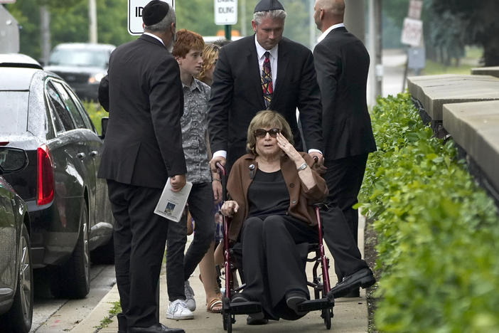 Linda Straus, widow of Stephen Straus, who was killed Monday in a mass shooting at the Fourth of July parade in Highland Park, Ill., arrives for a funeral service with family members at the Jewish Reconstructionist Congregation on Friday in Evanston, Ill. Straus was buried earlier in a private family service.
