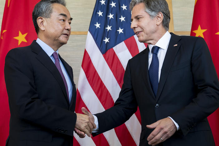 U.S. Secretary of State Antony Blinken (right) shakes hands with China's Foreign Minister Wang Yi during a meeting in Nusa Dua on the Indonesian resort island of Bali on Saturday.