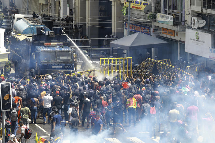 Police use water canon and tear gas to disperse the protesters in Colombo, Sri Lanka, on Saturday.