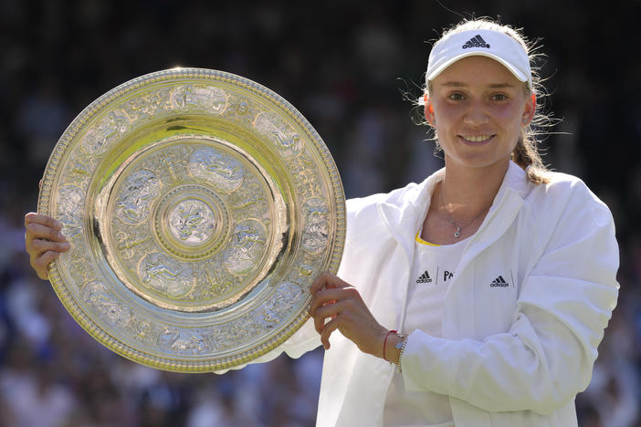 Kazakhstan's Elena Rybakina holds the trophy as she celebrates after beating Tunisia's Ons Jabeur to win the Wimbledon women's single final Saturday.