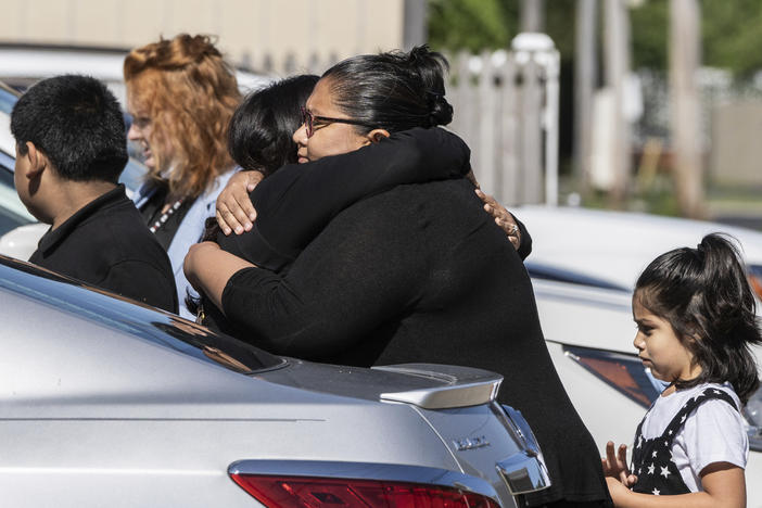 Mourners hug Saturday outside Memorial Chapel Funeral Home in Waukegan, Ill., during funeral services for Eduardo Uvaldo, who was killed Monday during a mass shooting at the Fourth of July parade in Highland Park.