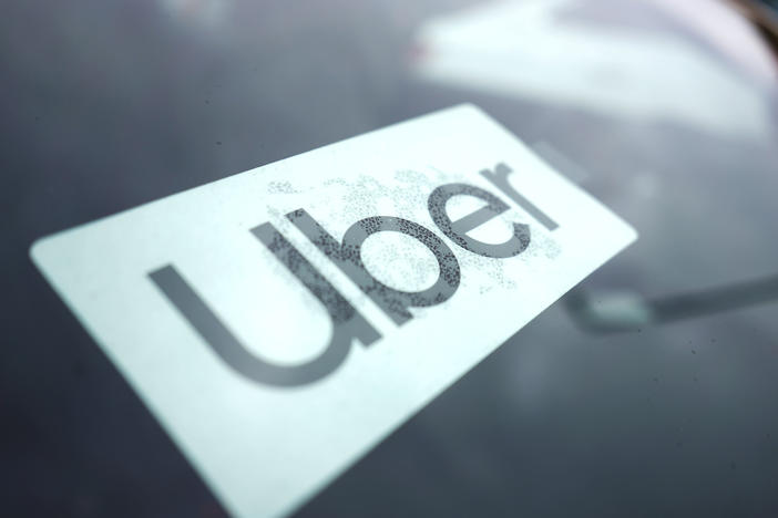 An Uber sign is displayed inside a car in Palatine, Ill., Thursday, Feb. 10, 2022.