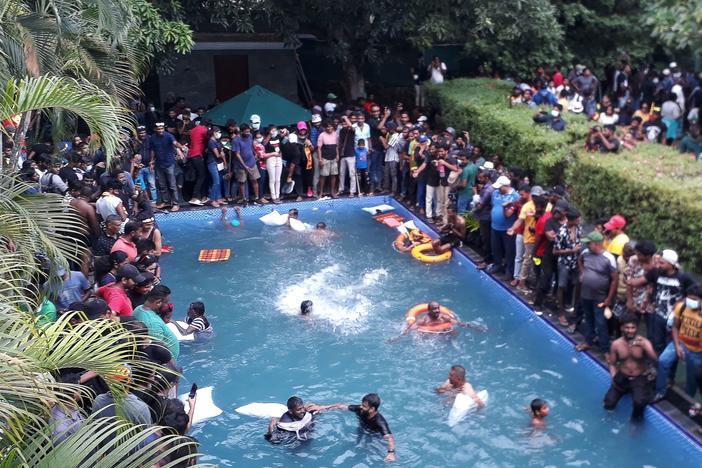 Protesters demanding the resignation of Sri Lanka's President Gotabaya Rajapaksa swim in a pool inside the compound of Sri Lanka's Presidential Palace in Colombo on July 9, 2022.