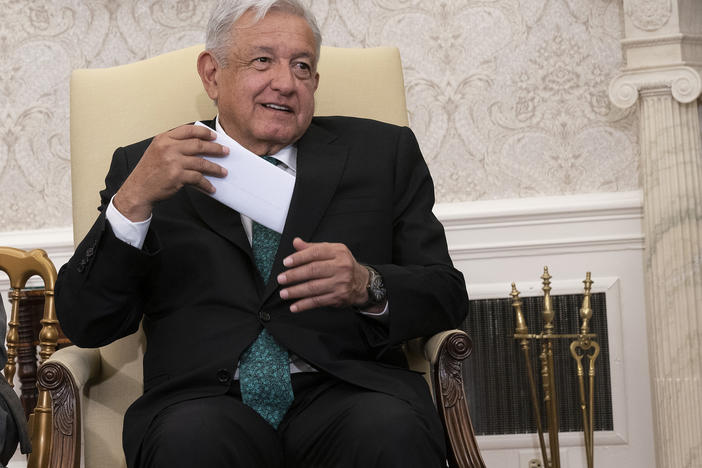 Mexican President Andrés Manuel López Obrador pulls out his remarks in the Oval Office.