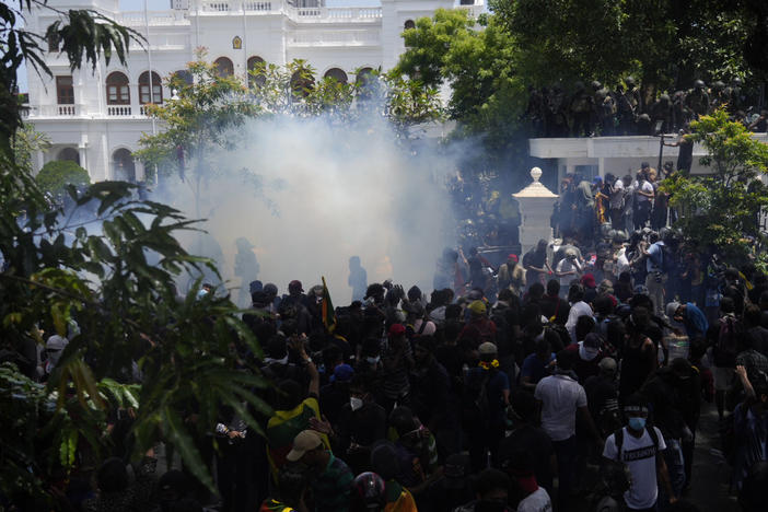 Police use tear gas as Sri Lankan protesters storm prime minister Ranil Wickremesinghe 's office in Colombo, Sri Lanka, Wednesday, July 13, 2022.