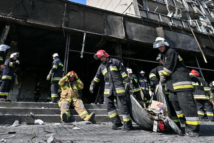 Firefighters remove rubble following a Russian airstrike in the central city of Vinnytsia on Thursday that Ukrainian officials said killed more than 20 people and injured dozens more.