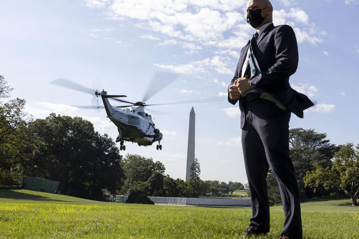 A U.S. Secret Service agent stands by as Marine One departs with President Biden aboard as he departs the White House in September 2021.