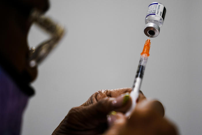 A syringe is prepared with the Pfizer COVID-19 vaccine at a vaccination clinic at the Keystone First Wellness Center in Chester, Pa., Dec. 15, 2021.