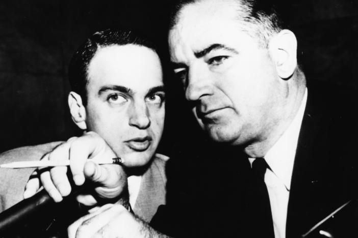 Attorney Roy Cohn, left, confers with red-hunting Sen. Joseph McCarthy, R-Wisc., during Senate hearings in 1954.