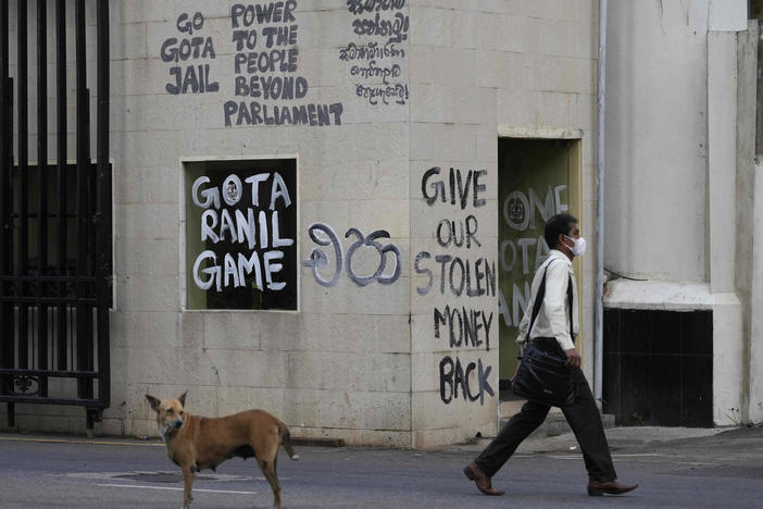 A man walks past a security point outside president's official residence in Colombo, Sri Lanka, on Friday.