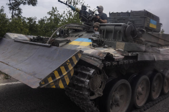 Ukrainian soldiers ride a tank on a road, in Stupochky, Donetsk region, eastern Ukraine, Sunday, July 10, 2022.