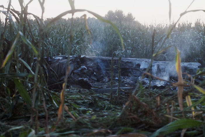 Debris of an Antonov cargo plane smolders in Palaiochori village in northern Greece, Sunday, July 17, 2022, after it reportedly crashed Saturday near the city of Kavala.