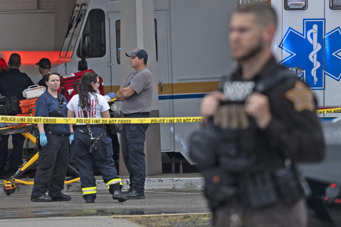 Emergency personnel gather after a deadly shooting Sunday, July 17, 2022, at the Greenwood Park Mall, in Greenwood, Ind.