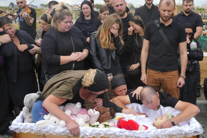 Relatives and friends attend the funeral on Sunday for Liza, a 4-year-old girl killed by Russia's attack on Vinnytsia, Ukraine. The girl was among 23 people killed in Thursday's missile strike in Vinnytsia. Her mother, Iryna Dmytrieva, was among the scores injured.