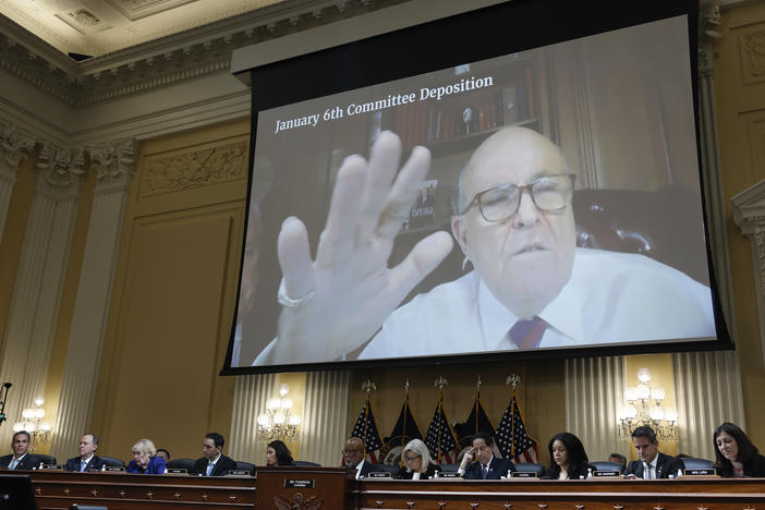 Rudy Giuliani's videotaped testimony appears on a video screen above members of the Select Committee to Investigate the January 6th Attack on the U.S. Capitol during its seventh hearing on July 12, 2022.