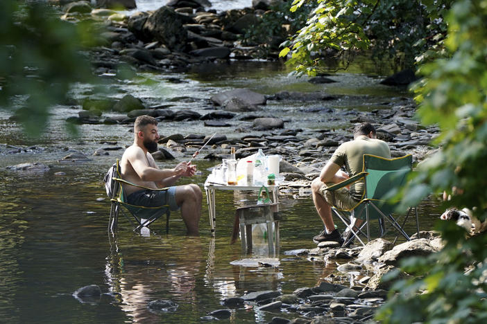 People escape the heatwave by taking a barbecue in a river near the village of Luss in Argyll and Bute on the west bank of Loch Lomond, Scotland, Monday July 18, 2022.