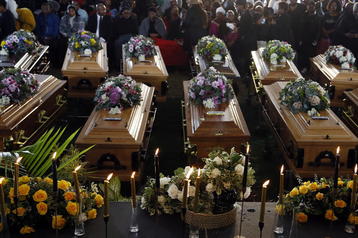 Coffins of 21 teenagers who died in a mysterious tragedy at a nightclub in the early hours of June 26 are lined up during their funeral held in Scenery Park, East London, South Africa, on July 6. The toxic chemical methanol has been identified as a possible cause of the deaths.