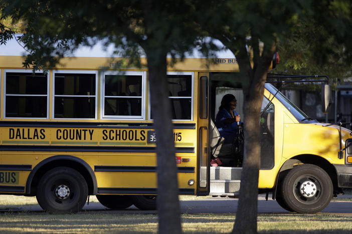 A Dallas Independent School District bus departs L.L. Hotchkiss Elementary school after dropping off students, Thursday, Oct. 2, 2014, in Dallas.