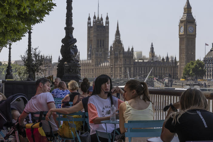 Residents of London enjoy some shade on Tuesday, as the United Kingdom recorded its hottest temperature ever.