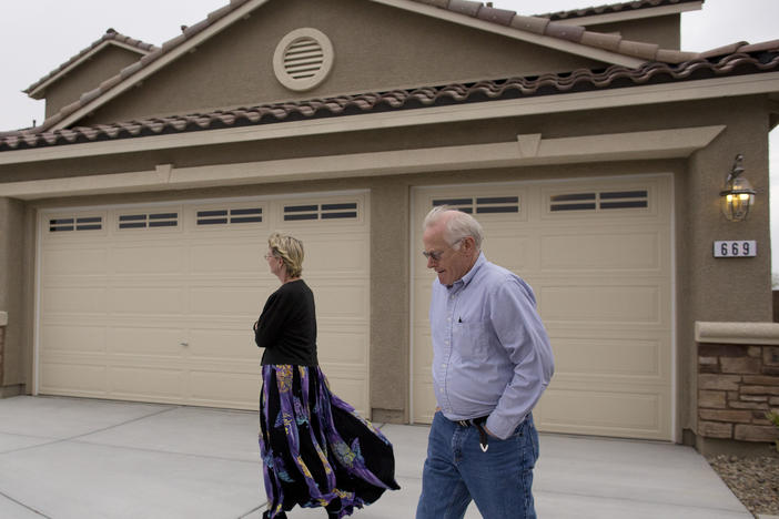 In this Friday, April 13, 2012 photo, Kelly, left, and Bill Noorish walk around a model a Lennar Next-Gen multigenerational home, in Las Vegas.