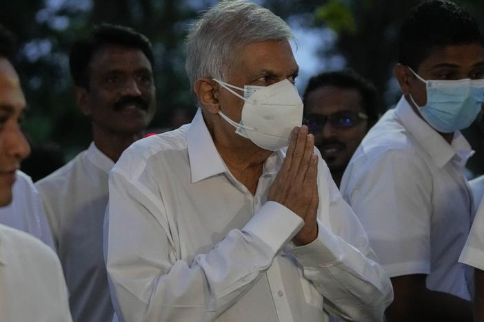 President-elect Ranil Wickremesinghe greats supporters upon his arrival at a buddhist temple in Colombo, Sri Lanka on Wednesday.