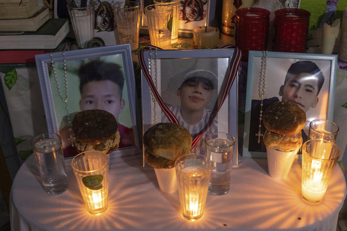 Photos of Jair Valencia, left, Misael Olivares, center, and Yovani Valencia are displayed on an altar at their home in San Marcos Atexquilapan, Mexico, on July 13, 2022. The three were among a group of migrants who died of heat and dehydration in a locked tractor-trailer abandoned by smugglers on the outskirts of San Antonio on June 27.