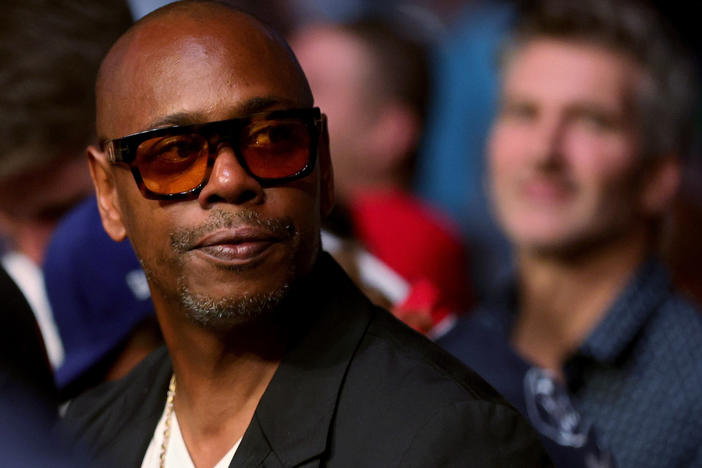 Dave Chappelle looks on during a UFC event on July 10, 2021, in Las Vegas. The comedian's show in Minneapolis was suddenly moved to another venue Wednesday night.