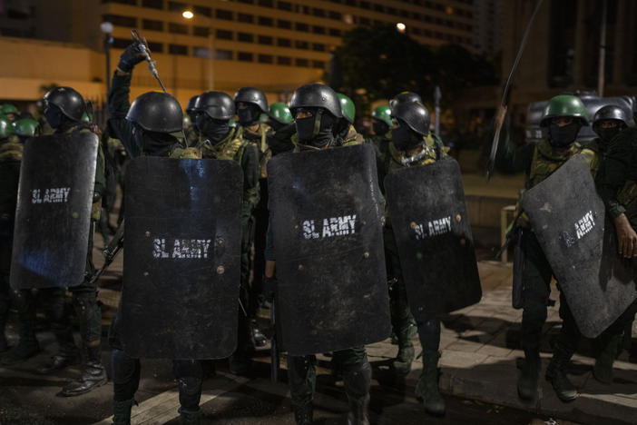 Army soldiers arrive to remove protesters and their tents from the site of a protest camp outside the Presidential Secretariat in Colombo, Sri Lanka, on Friday.