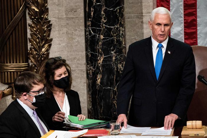 Then-Vice President Mike Pence is seen presiding over a joint session of Congress to certify the 2020 Electoral College results after a mob of pro-Trump supporters stormed the Capitol. Proposed changes to the Electoral Count Act would clarify the vice president's role in counting states' electoral votes.
